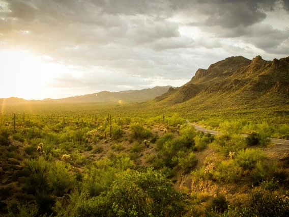 Sun shining through clouds over Gates Pass near Tucson, AZ