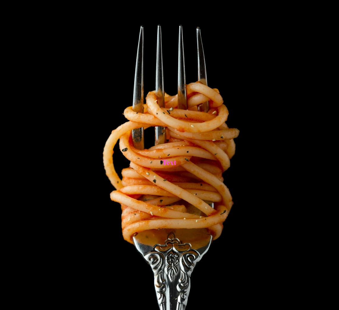 Pasta with tomato sauce wrapped on a fork