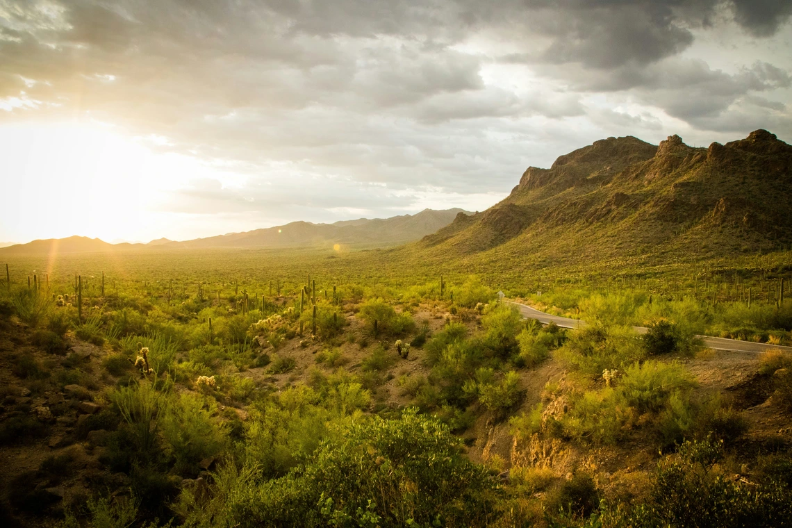 Sun shining through clouds over Gates Pass near Tucson, AZ