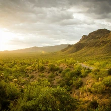 Sun shining through clouds over Gates Pass near Tucson, AZ