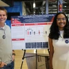 Students stand with their research poster on social prescribing
